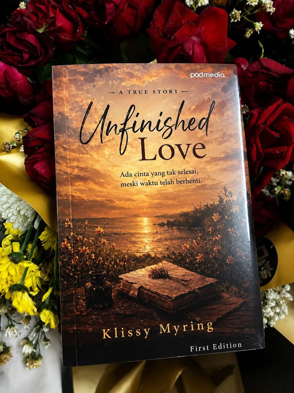 Buku Unfinished Love edisi pertama di antara mawar merah